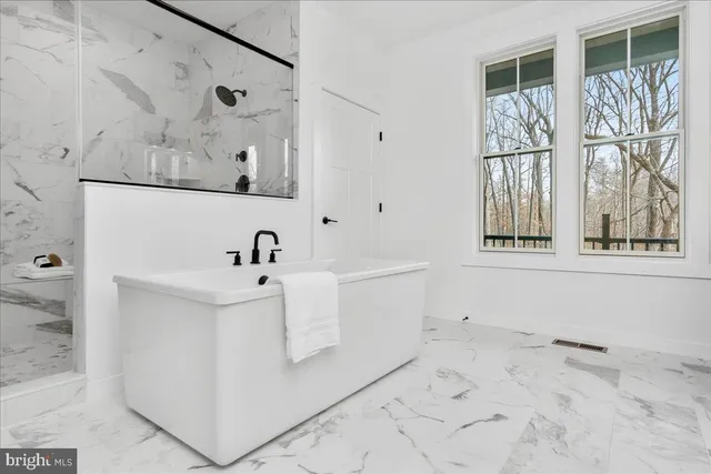 a view of a backyard with a large window and wooden fence