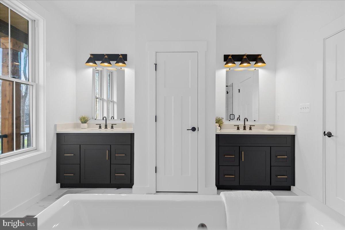 3520 Castle Way Davidsonville, MD 21035 - Photo 49 of 87 Elegant dual vanities in a bright bathroom.