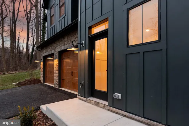 a view of a hallway with wooden floor and stairs