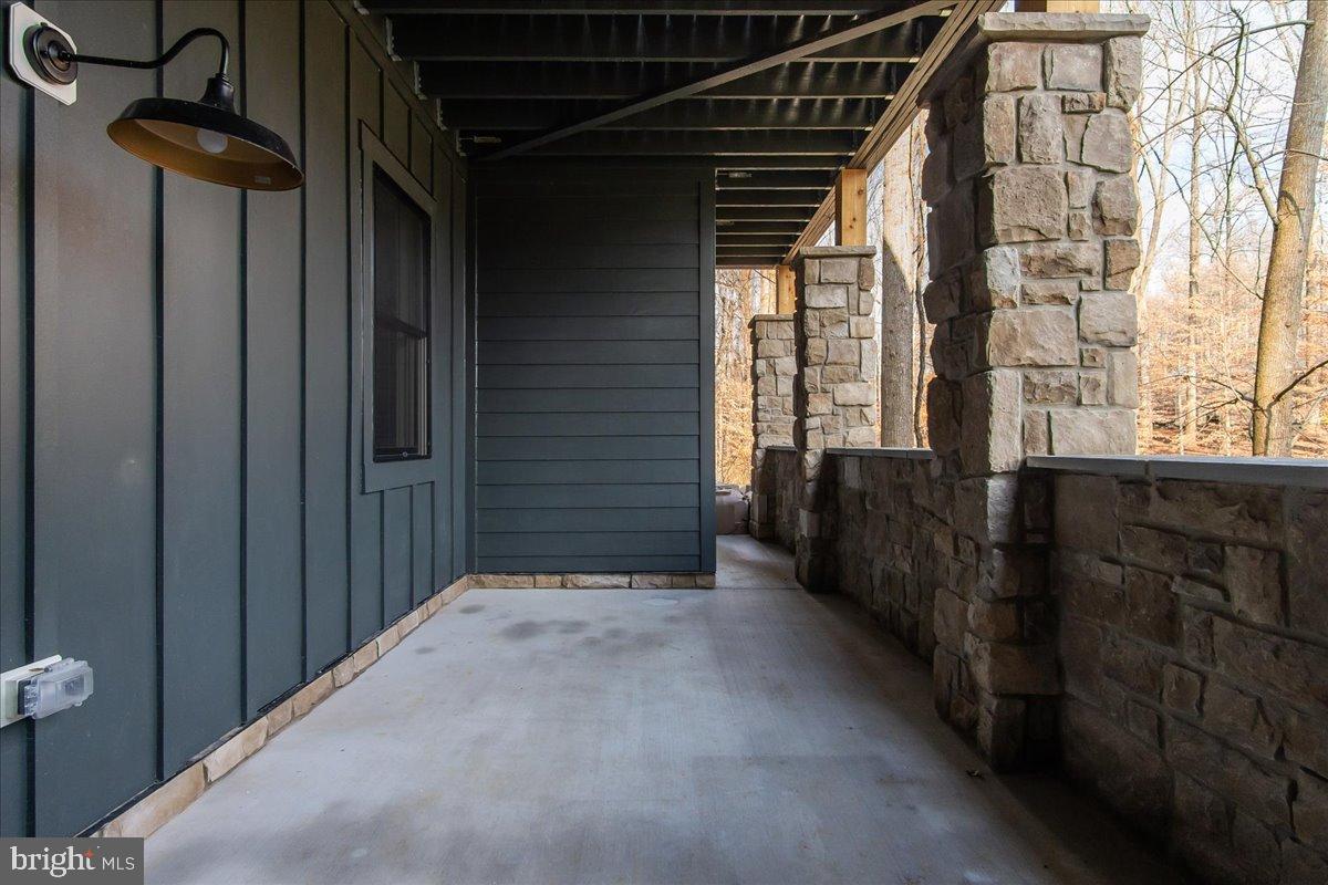 3520 Castle Way Davidsonville, MD 21035 - Photo 9 of 87 Serene outdoor passageway with stone accents.