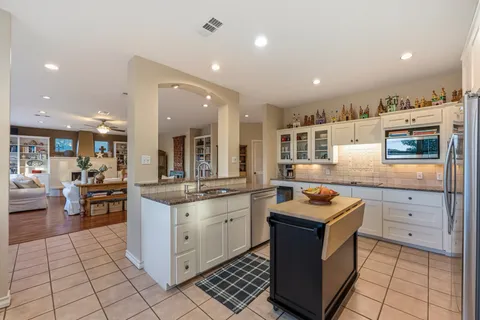 a kitchen with stainless steel appliances granite countertop a stove and a sink