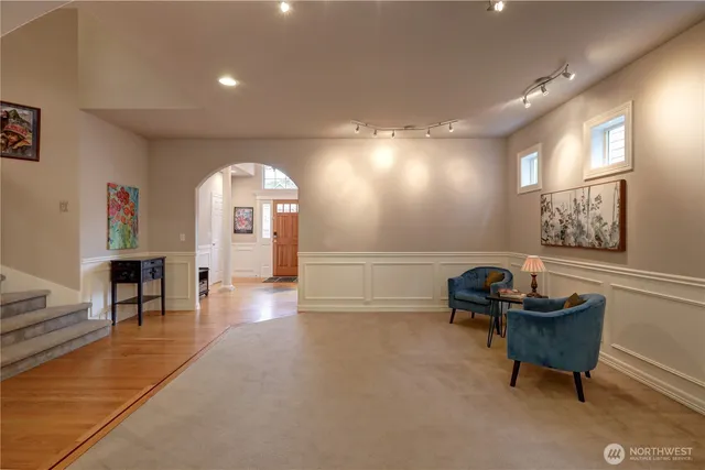 a living room with furniture and a chandelier