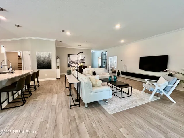 a kitchen with stainless steel appliances kitchen island granite countertop a dining table chairs and granite counter tops