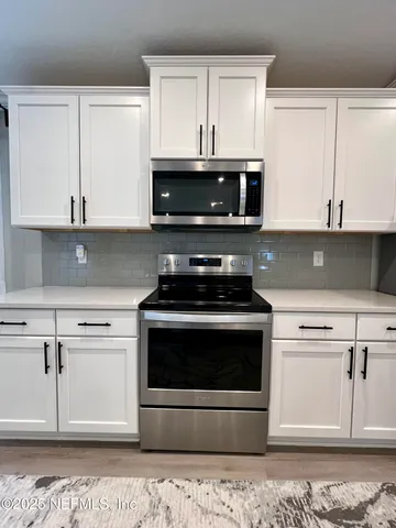 a bathroom with a shower sink and mirror