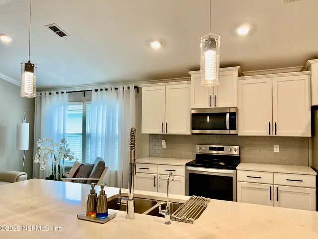 a spacious bathroom with a sink double vanity and a mirror