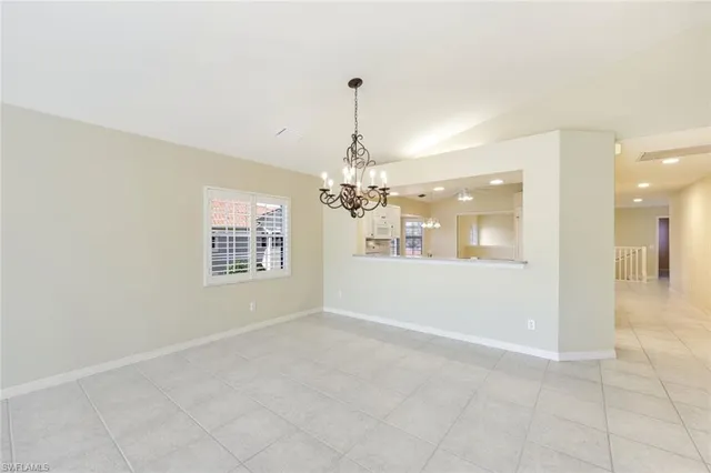 a view of a room with a chandelier fan and windows