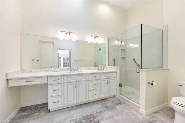 a spacious bathroom with a granite countertop sink mirror and toilet