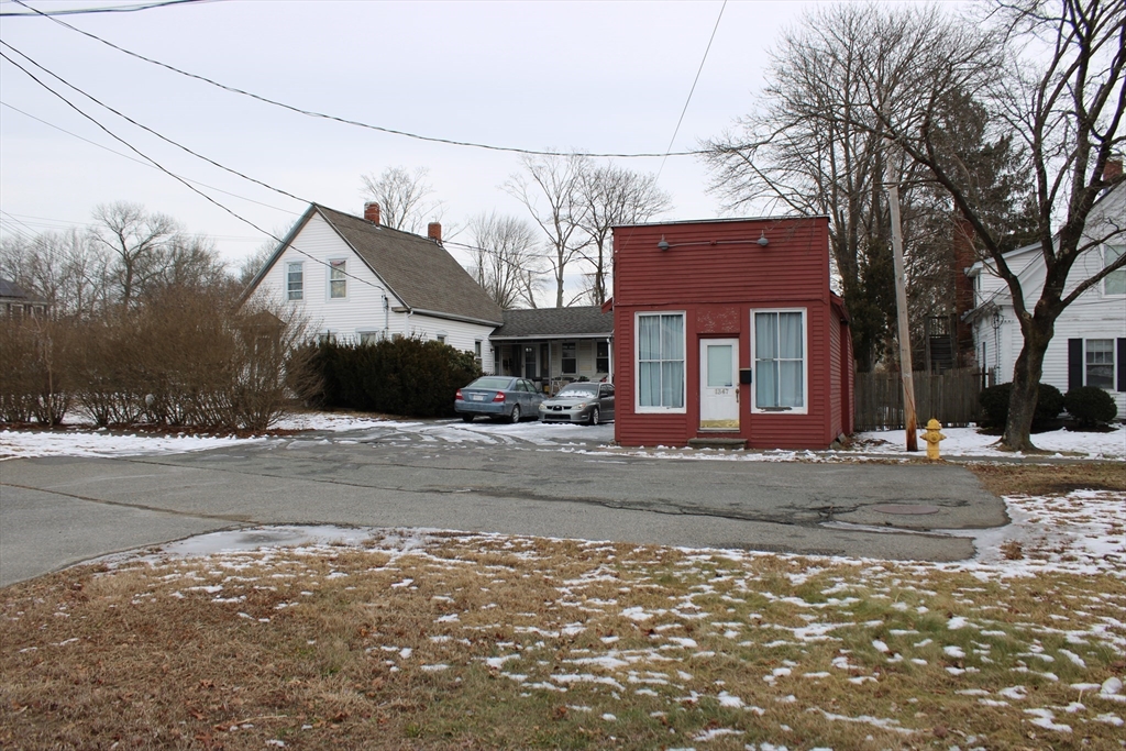 a view of a house with a yard next to a road