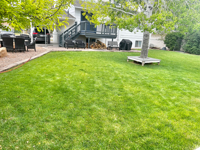 570 250 East Parowan, UT 84761 - Photo 26 of 27 Expansive green lawn with a mature tree featuring a built-in tree surround
