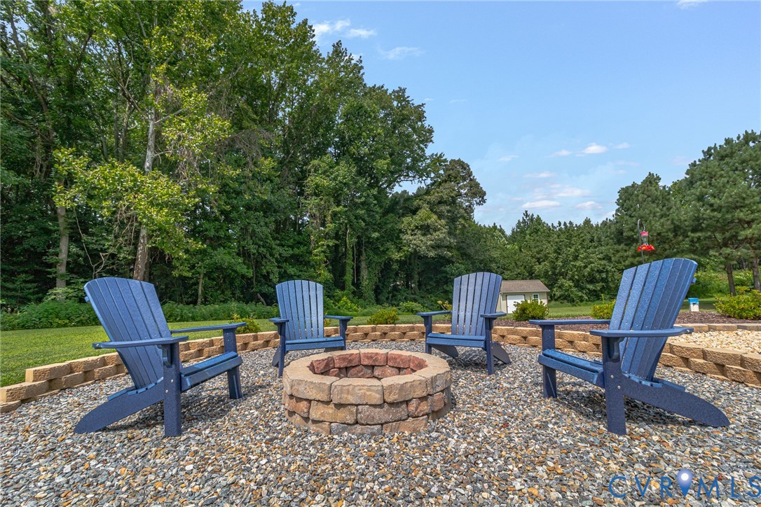 184 Crosshills Road Heathsville, VA 22473 - Photo 13 of 44 Gravel patio area featuring a stone fire pit and a