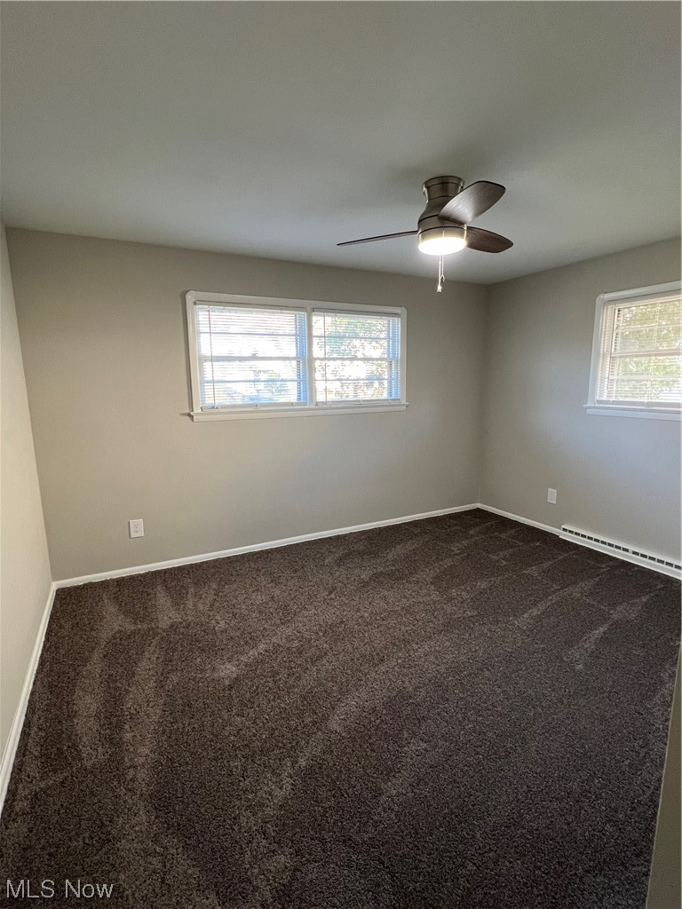 19306 Libby Road Maple Heights, OH 44137 - Photo 18 of 33 Carpeted spare room with a baseboard heating unit and ceiling fan