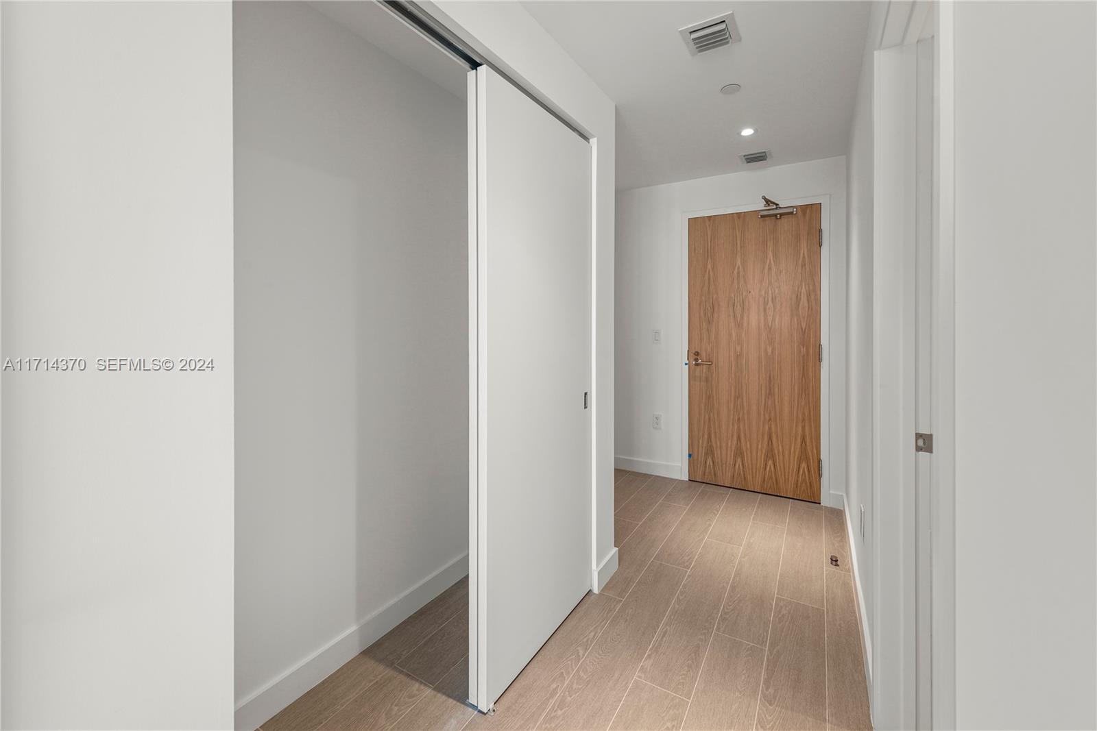 500 Alton Road, Unit 908 Miami Beach, FL 33139 - Photo 22 of 28 a view of hallway with wooden floor