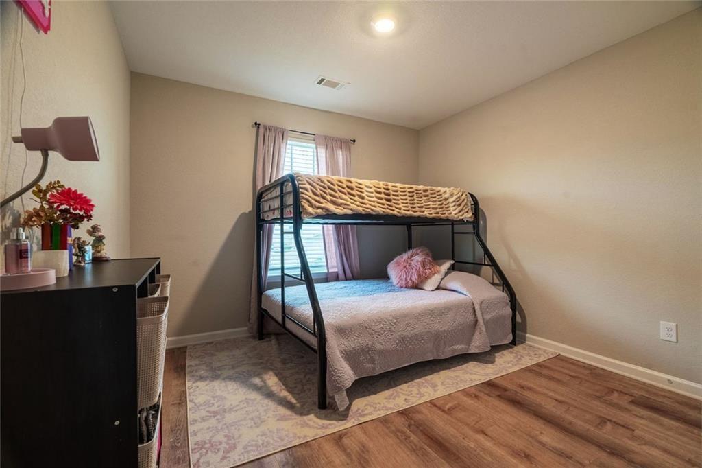 735 Walnut Creek Circle Pendergrass, GA 30567 - Photo 14 of 29 a bedroom with bed and wooden floor