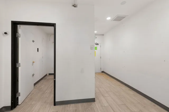 an empty room with closet and windows