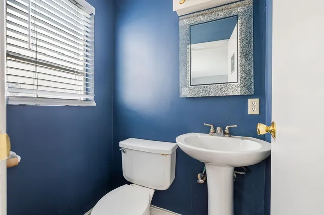 a view of a room with wooden floor and white walls