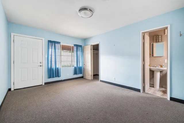 a bathroom with a toilet a sink and a window
