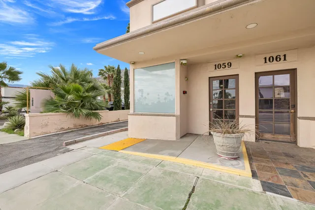 a bathroom with a granite countertop toilet sink and mirror