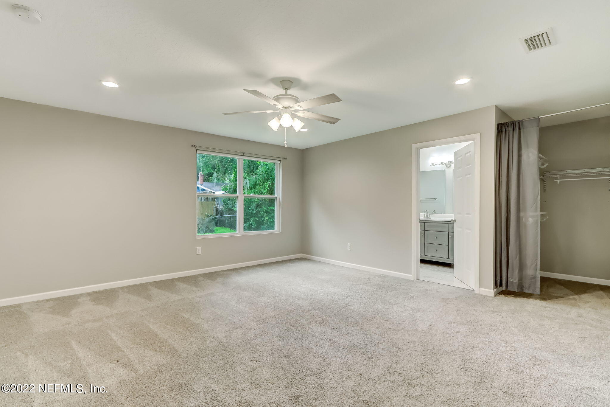 5218 Sunderland Road Jacksonville, FL 32210 - Photo 8 of 23 an empty room with chandelier fan and windows