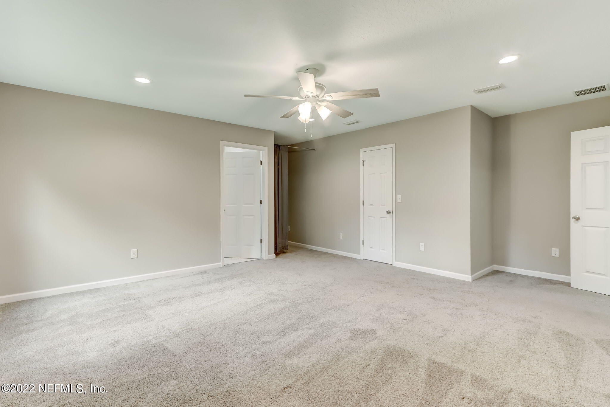 5218 Sunderland Road Jacksonville, FL 32210 - Photo 10 of 23 wooden floor in an empty room with a ceiling fan