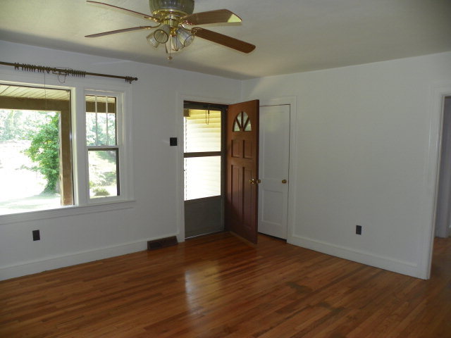1949 The Great Road Fieldale, VA 24089 - Photo 2 of 6 a view of an empty room with wooden floor and a window