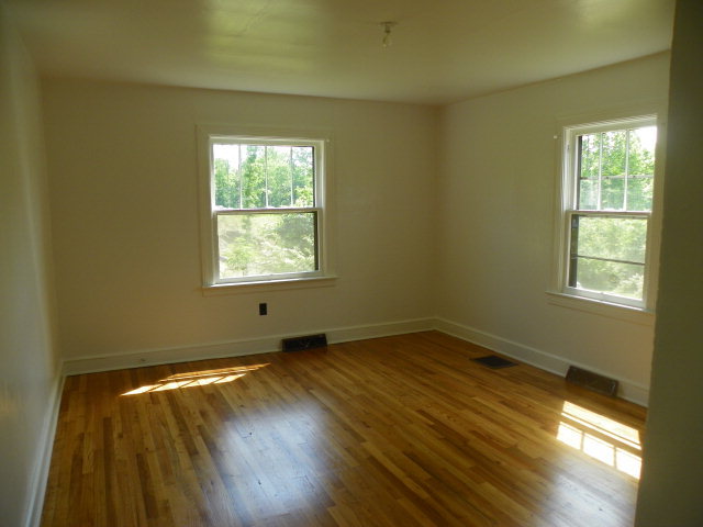 1949 The Great Road Fieldale, VA 24089 - Photo 3 of 6 a view of an empty room with wooden floor and a window