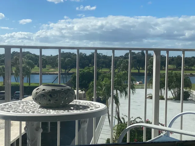 a view of a balcony with a table and chairs