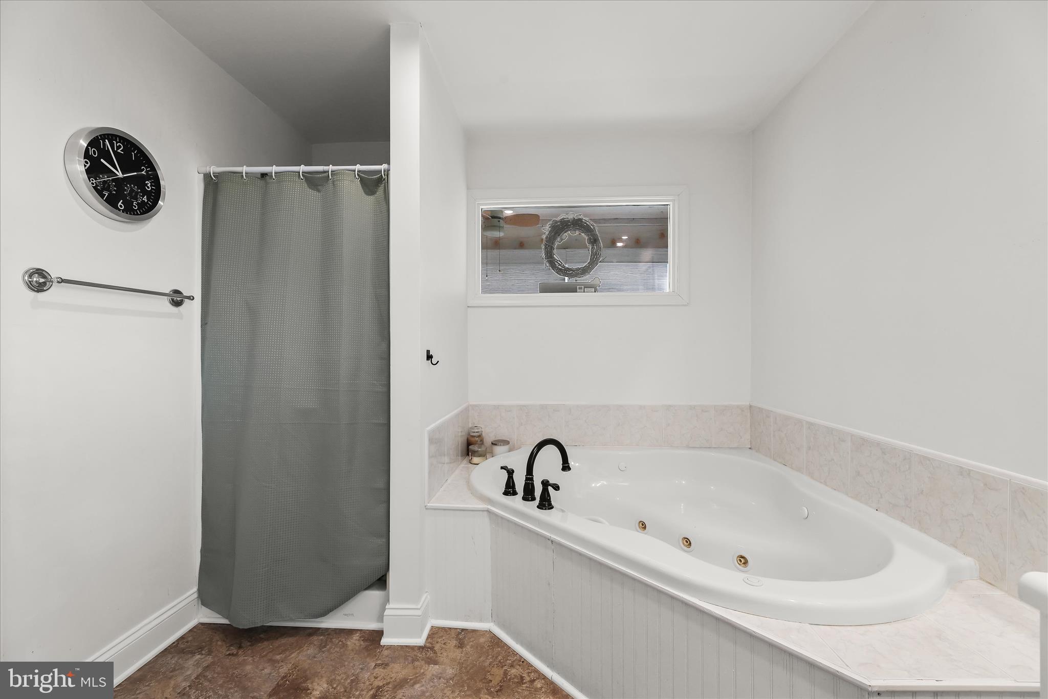 13041 Penn Shop Road Mount Airy, MD 21771 - Photo 32 of 57 a bathroom with a bathtub and a shower