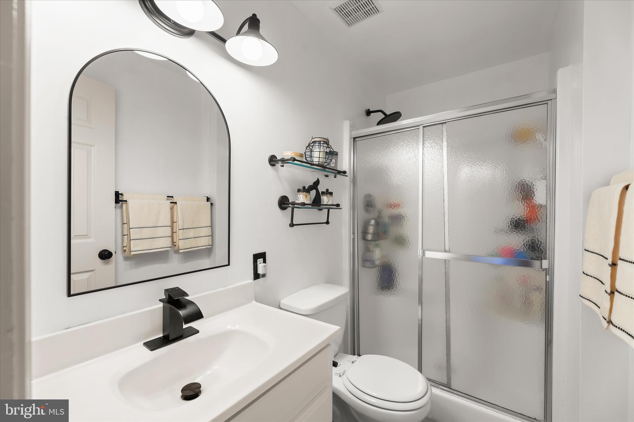 13041 Penn Shop Road Mount Airy, MD 21771 - Photo 38 of 57 a bathroom with a sink a toilet and shower