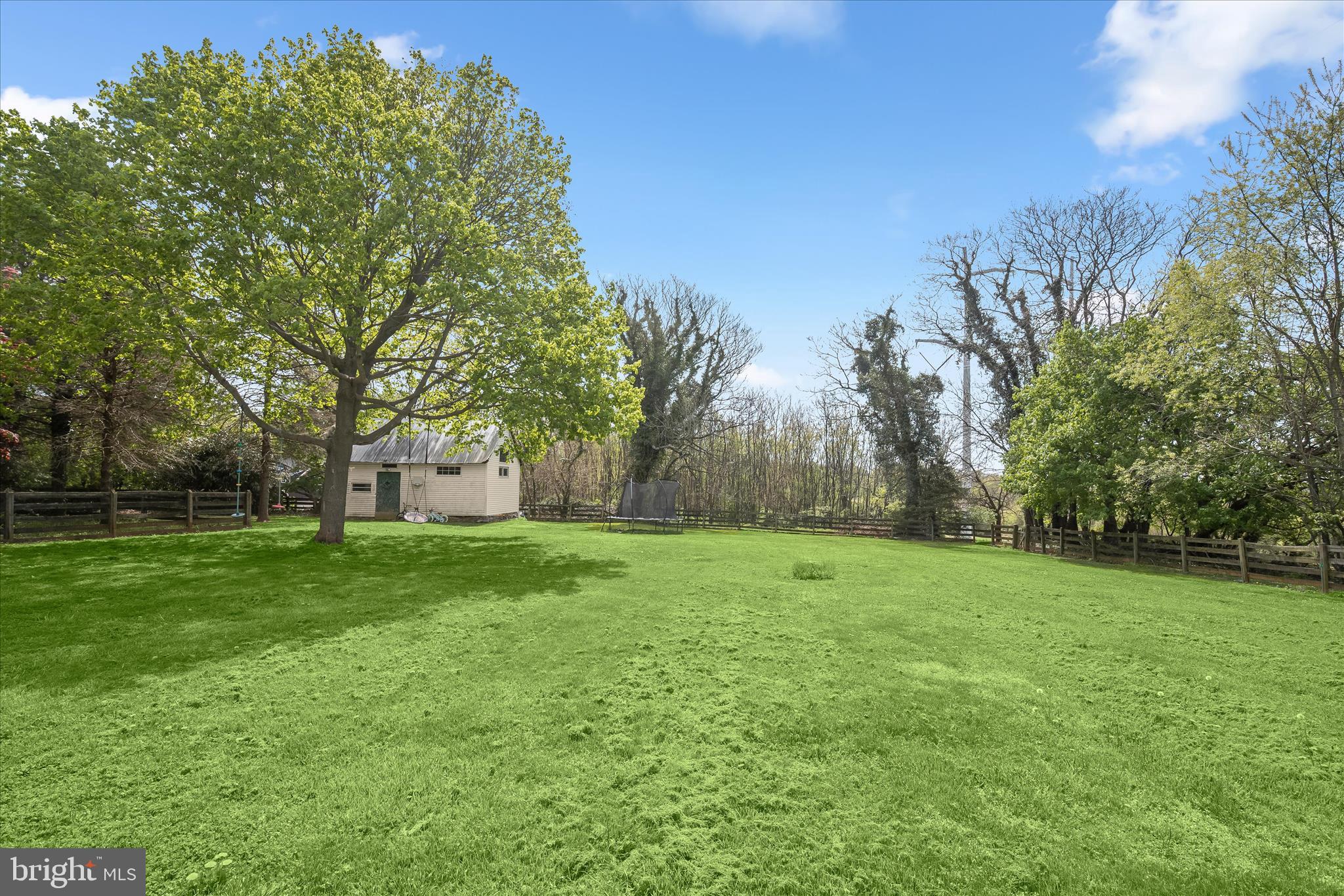 13041 Penn Shop Road Mount Airy, MD 21771 - Photo 43 of 57 a view of a grassy field with trees in the background