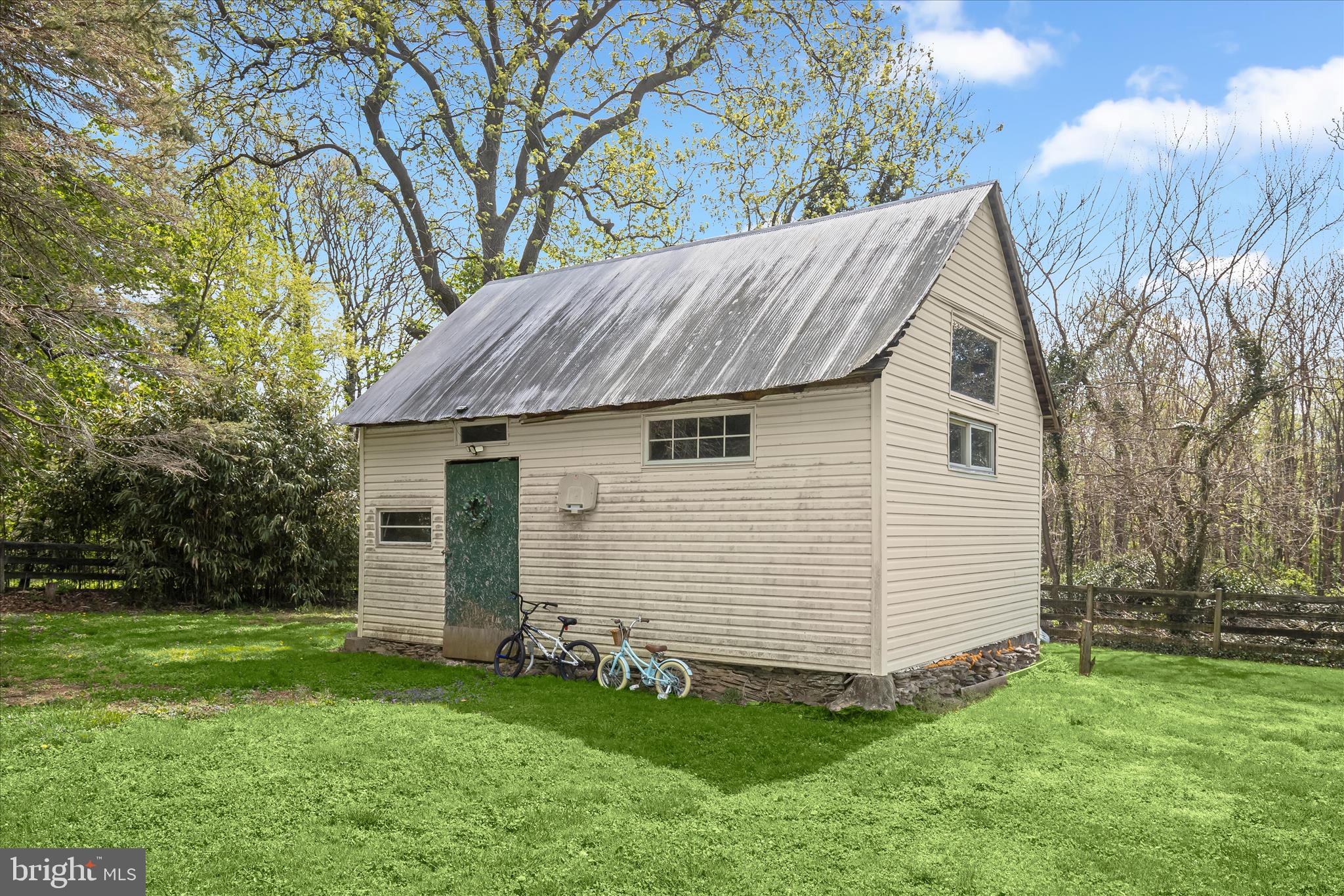 13041 Penn Shop Road Mount Airy, MD 21771 - Photo 46 of 57 a view of a white house with a small yard and a large tree