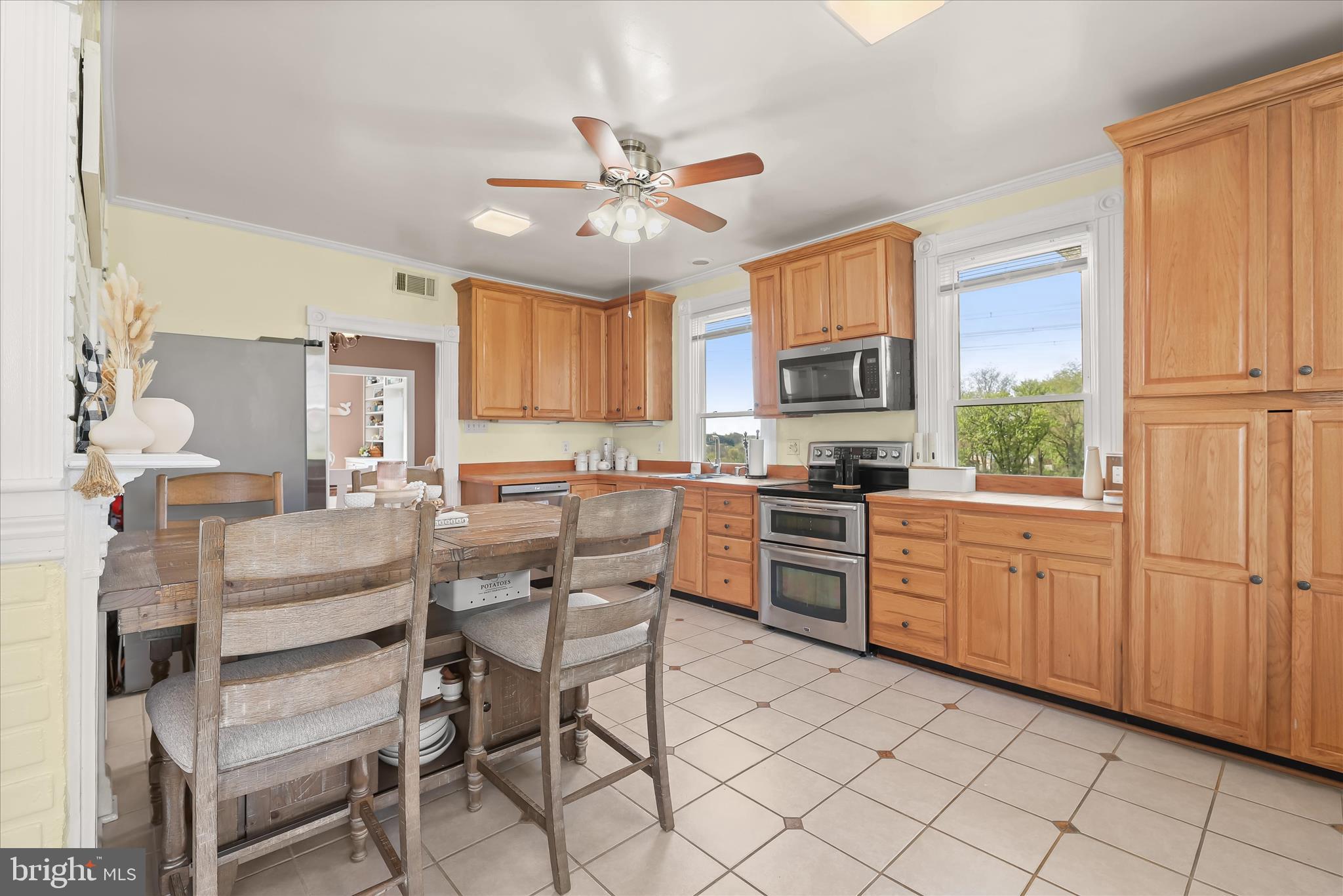 13041 Penn Shop Road Mount Airy, MD 21771 - Photo 9 of 57 a kitchen with stainless steel appliances granite countertop wooden cabinets a stove a sink a dining table and chairs