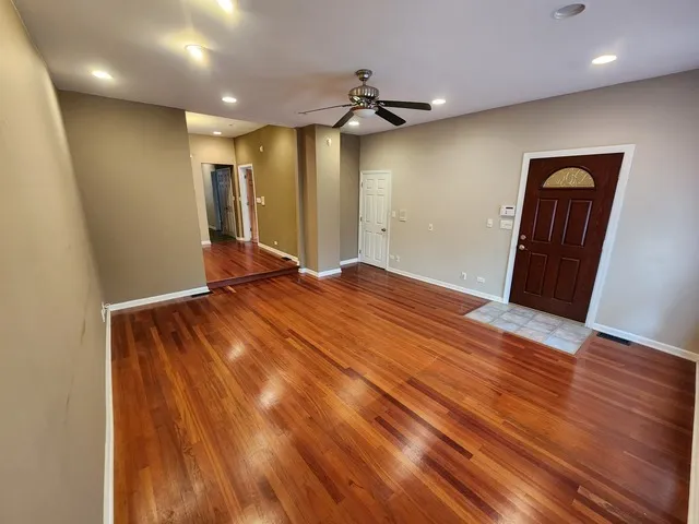 a view of livingroom with hardwood floor and front door