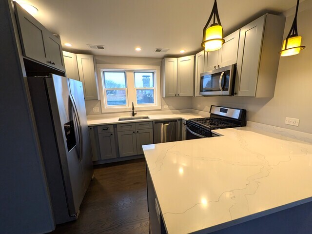3610 South Seeley Avenue Chicago, IL 60609 - Photo 18 of 26 a kitchen with stainless steel appliances a refrigerator sink and wooden floor