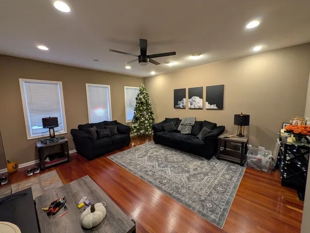 a living room with furniture and wooden floor