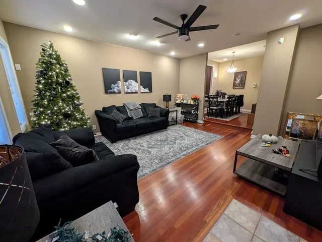 a living room with furniture and a potted plant