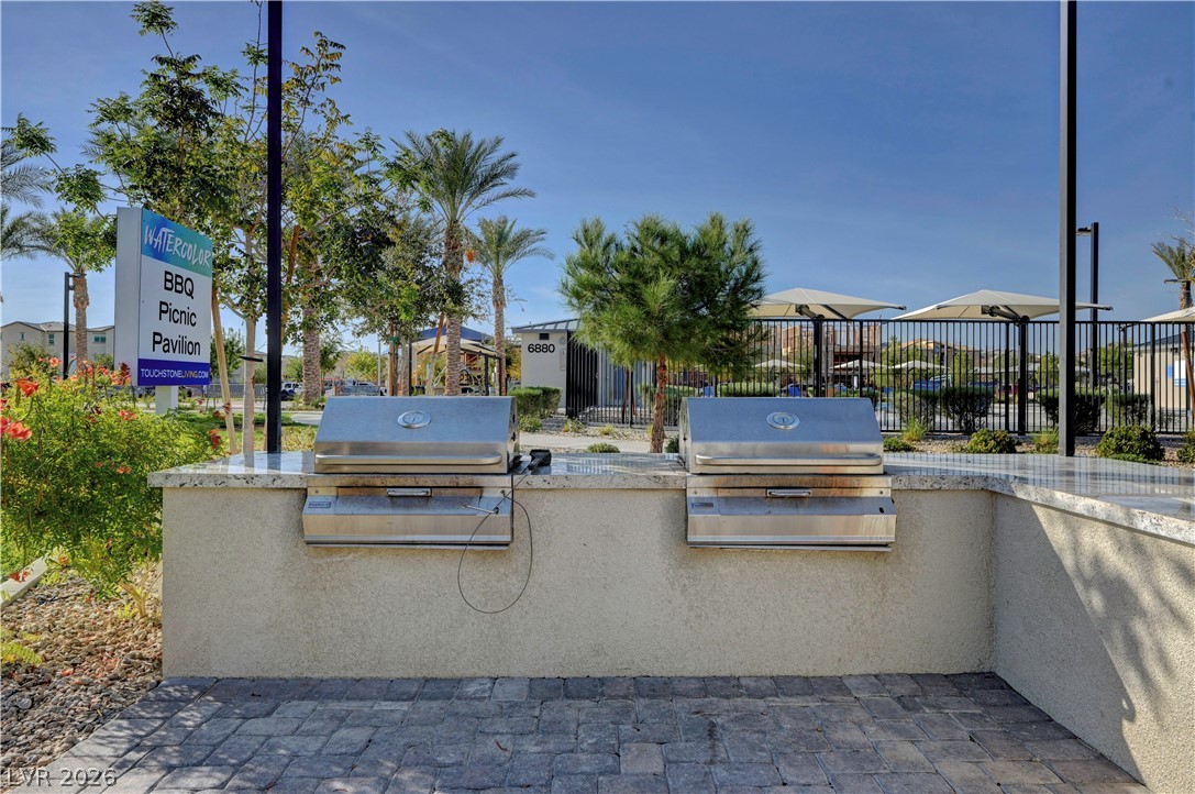 6924 Spicy Merlot Street North Las Vegas, NV 89086 - Photo 77 of 83 An outdoor cooking area with two built-in grills stands ready for community gatherings.
