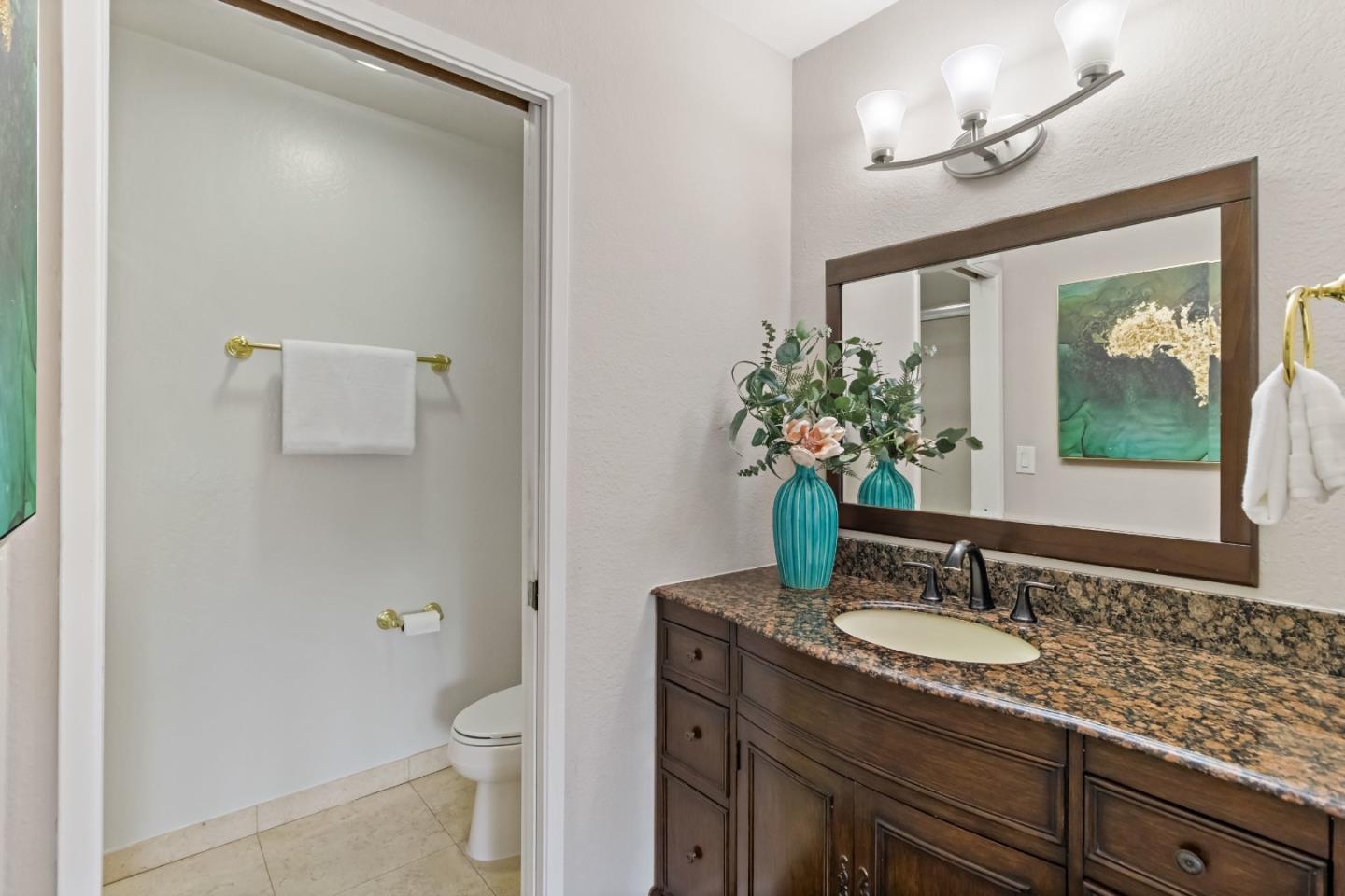 20179 NW Square Cupertino, CA 95014 - Photo 21 of 50 a bathroom with a granite countertop sink a toilet and mirror