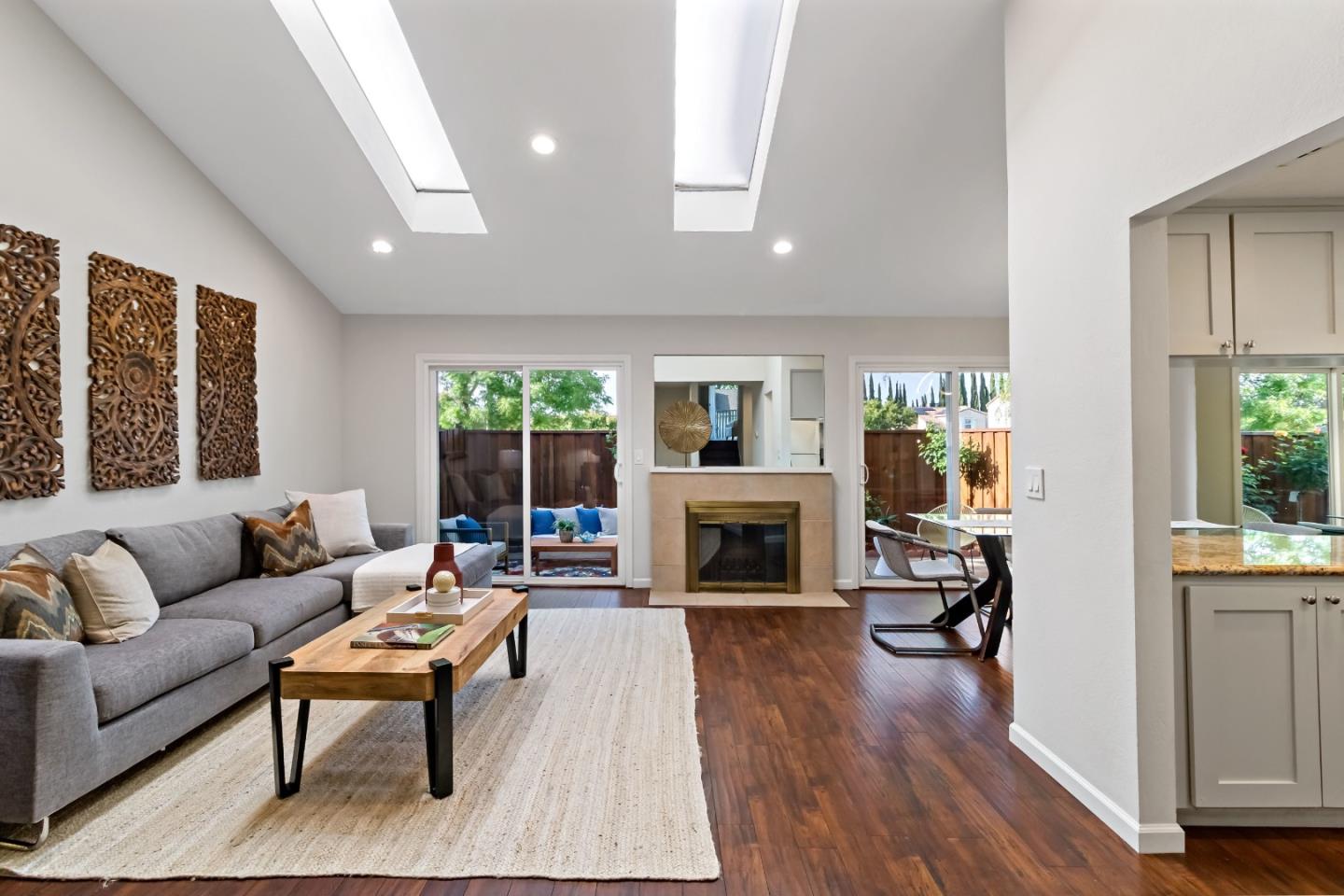 20179 NW Square Cupertino, CA 95014 - Photo 9 of 50 a living room with furniture a fireplace and a table