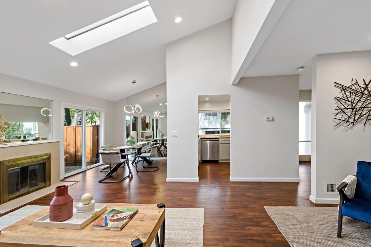 20179 NW Square Cupertino, CA 95014 - Photo 10 of 50 a living room with furniture a fireplace and wooden floor
