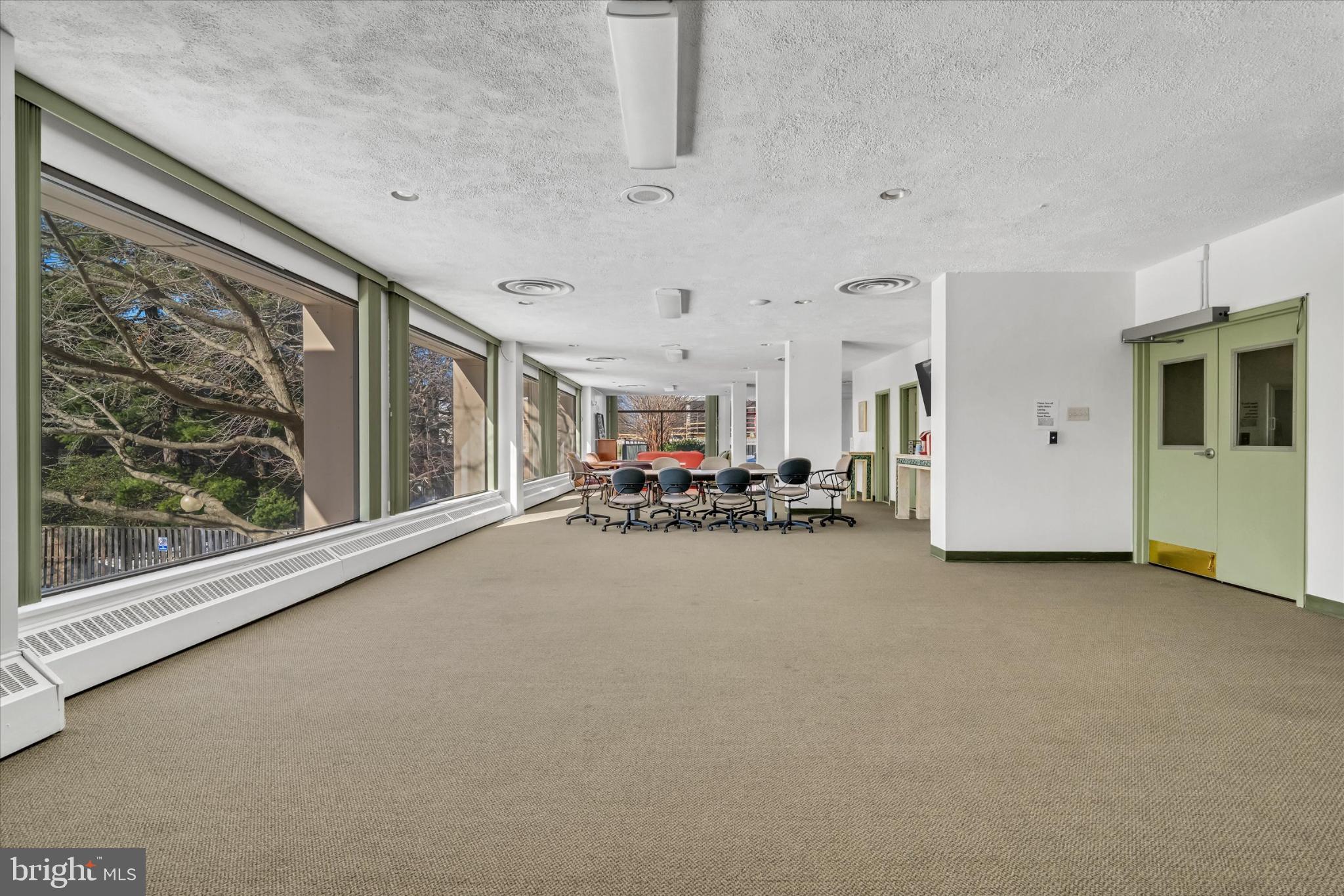 4141 North Henderson Road, Unit 104 Arlington, VA 22203 - Photo 20 of 23 Spacious party room with abundant natural light.