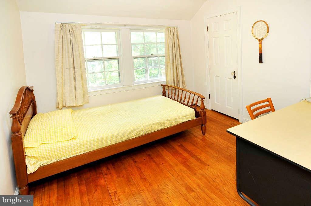 4523 Sleaford Road Bethesda, MD 20814 - Photo 13 of 23 a bed sitting in a bedroom next to a window