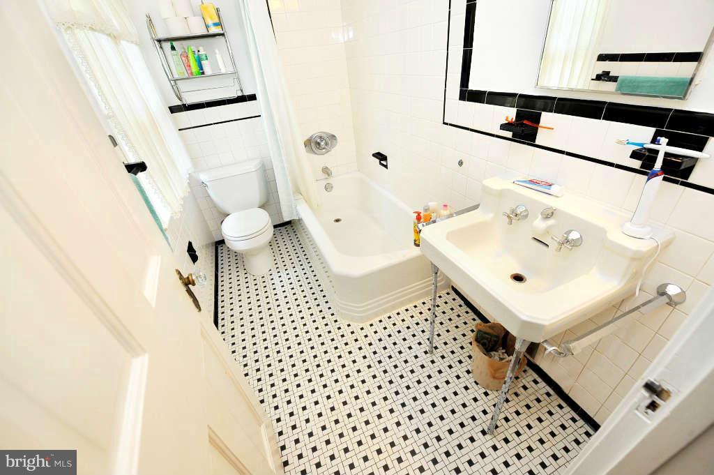 4523 Sleaford Road Bethesda, MD 20814 - Photo 14 of 23 a bathroom with a sink a toilet and shower