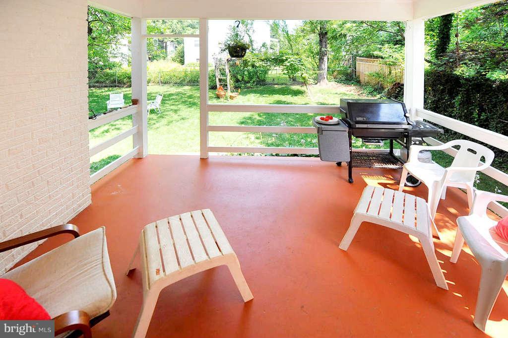 4523 Sleaford Road Bethesda, MD 20814 - Photo 9 of 23 a view of a patio with table and chairs and couches with wooden floor