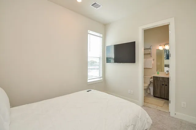 a bedroom with a bed and a flat screen tv