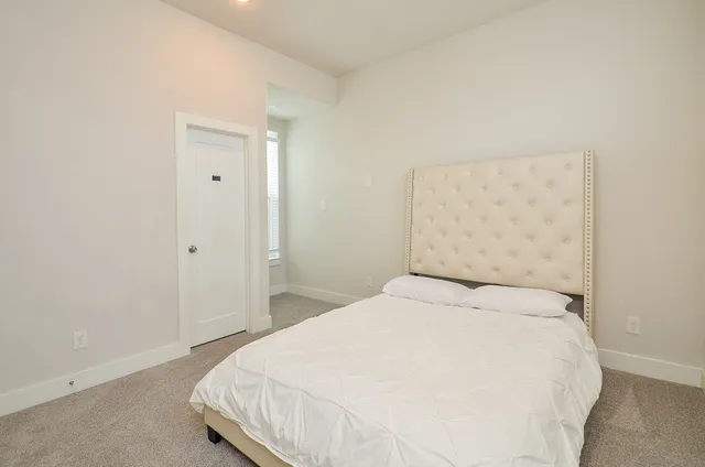 a large white bed in a white room
