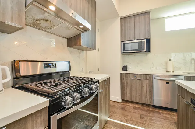 a kitchen with stainless steel appliances granite countertop a stove and a sink