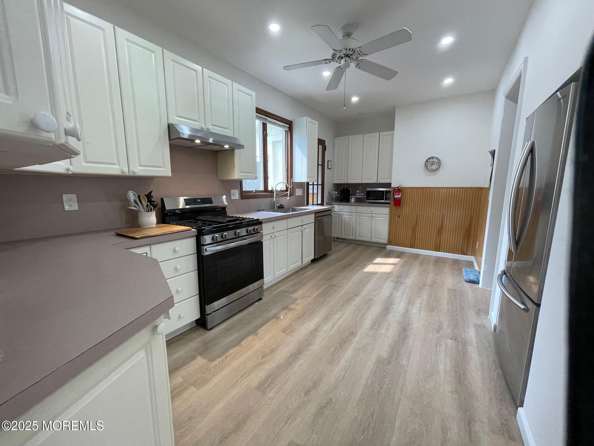 205 Euclid Avenue Allenhurst, NJ 07711 - Photo 3 of 6 a kitchen with granite countertop a refrigerator stove top oven and sink