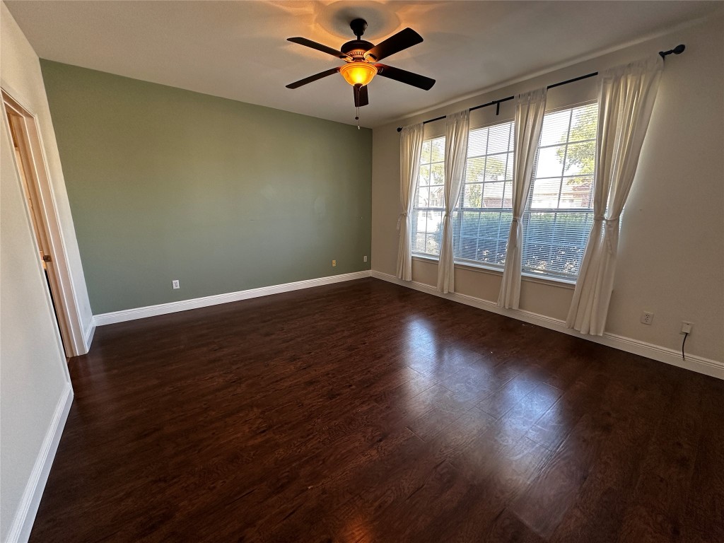 1041 Disraeli Circle Pflugerville, TX 78660 - Photo 13 of 29 a view of empty room with wooden floor and fan