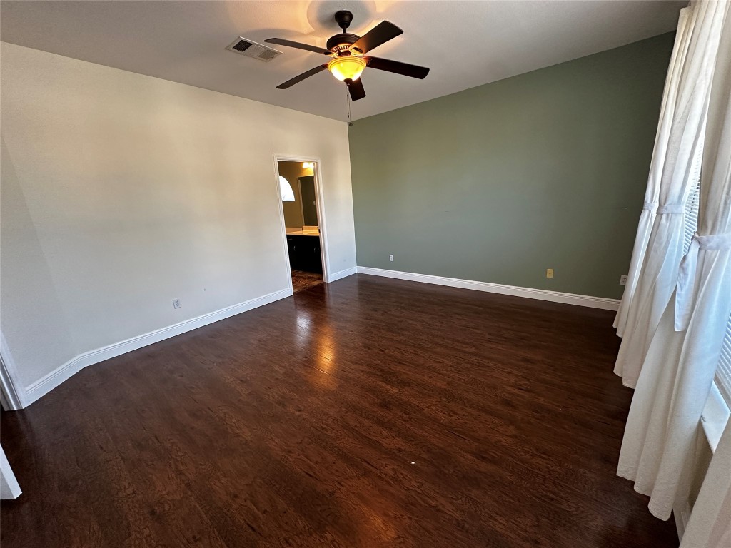 1041 Disraeli Circle Pflugerville, TX 78660 - Photo 15 of 29 a view of an empty room with wooden floor and a window