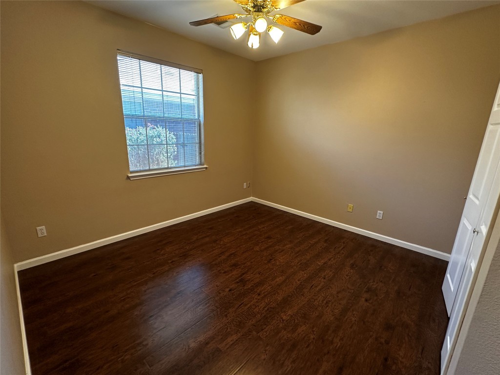 1041 Disraeli Circle Pflugerville, TX 78660 - Photo 23 of 29 a view of an empty room with wooden floor and a window